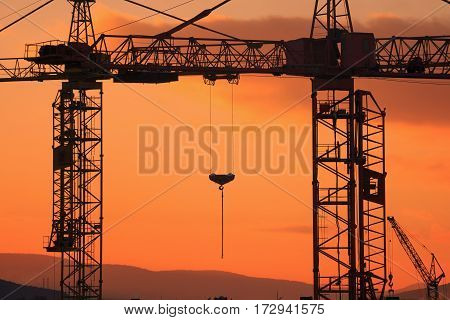 Construction Crane On The Sunset Background