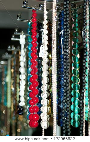 Many colorful Oriental beads and necklaces over the counter in the market