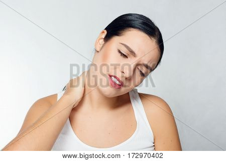 health people Sport and lifestyle concept - Tired Neck. Beautiful Young Woman Suffering From Neck Pain. Attractive Female Feeling Tired Exhausted Stressed. Girl Massaging Painful Neck With Hand.