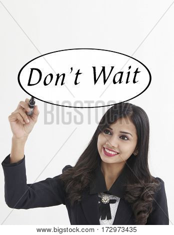 businesswoman holding a marker pen writing -don't wait