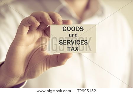 Businessman Holding Gst Goods And Services Tax Message Card