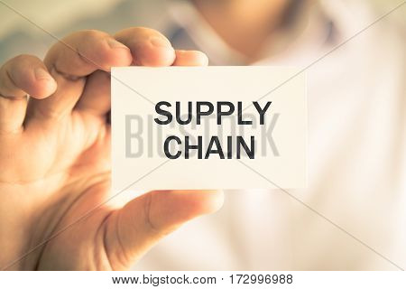 Businessman Holding Supply Chain Message Card