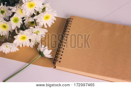 Blank area note book or diary with flower