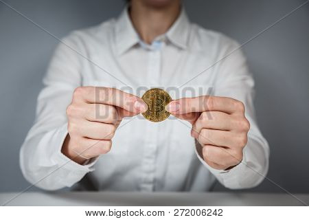 Golden Bitcoin In A Man Hand, Digitall Symbol Of A New Virtual Currency