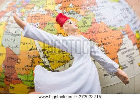 Swirling Dervish In Front Of A Globe On A Textured Background