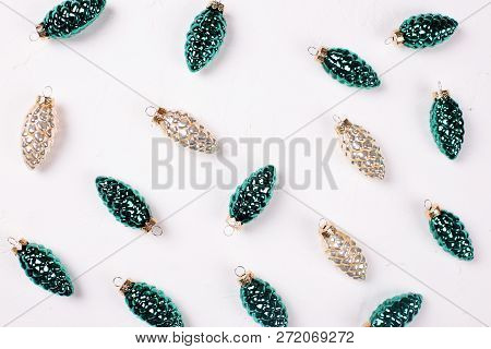 Christmas Or New Year Composition. Decorative Gold And Silver Pine Cones On Whitetextured Background