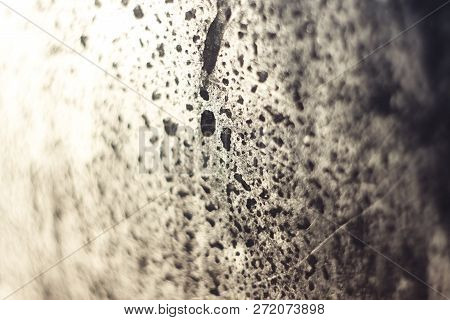 Background With Water Droplets On The Misted Glass Window, Illuminated By The Bright Sun