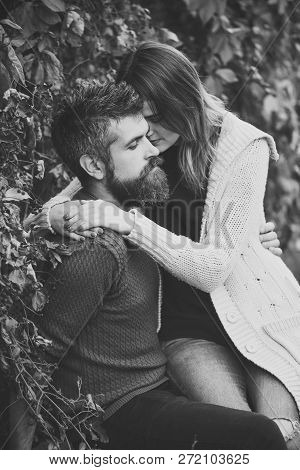 Couple In Love Hugs With Red Leaves On Background, Autumn Day. Man With Beard And Young Woman Wears 