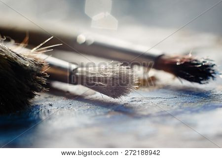 Stained Brush With The Bristles Lying On The Palette