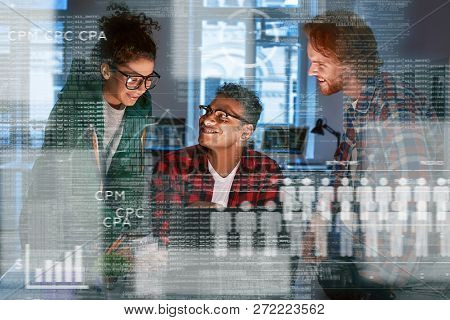 Young Team Of Marketing Department Are Looking Over The Data