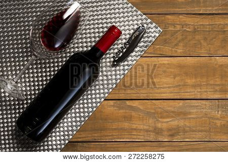 Bottle Of Wine Glass And Corkscrew On Wooden Background. Top View With Copy Space.
