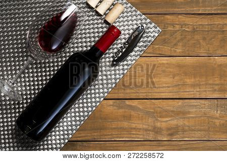 Bottle Of Wine Glass And Corkscrew On Wooden Background. Top View With Copy Space.