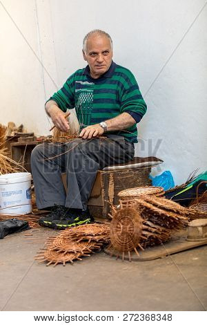 Camacha, Madeira, Portugal - April 19, 2018: A Basket Weaver At Work In The Factory Shop In Camacha 