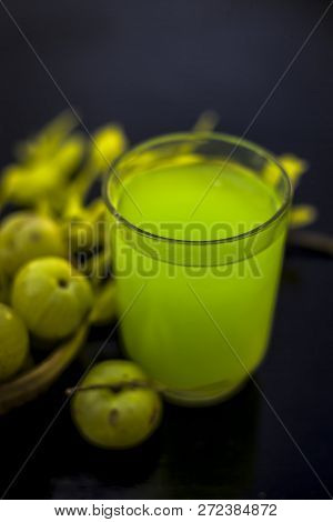 Close Up Of Extracted Beneficial Juice Of Amla Or Indian Gooseberry Or Phyllanthus Emblica In A Tran