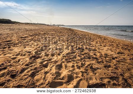 Deserted Sand Beach Sunny Weather Factory Tubes On Horizon