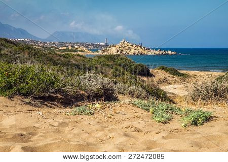 Desert Coastline With Sand Alagadi Beach Of Northern Cyprus And Factory And Mountains On Horizon