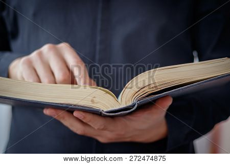 Hands Folded In Prayer On A Holy Bible In Church Concept For Faith, Spirtuality And Religion