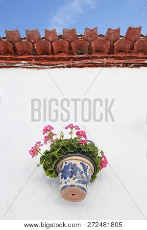 Arabic Red Tiled Rooftop With Geranium Flowerpot At Alfarnatejo, White Village On Malaga Mountains, 
