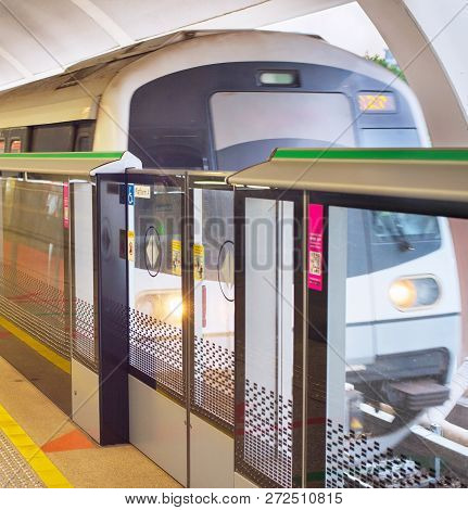 Light Rail Transit Train Arrives At A Station In Singapore. Metro Train Motion Blur