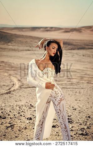 Girl In Dress In Sunny Desert. Bride And Wedding Ceremony. Elegance And Fashion Model. Wedding Fashi