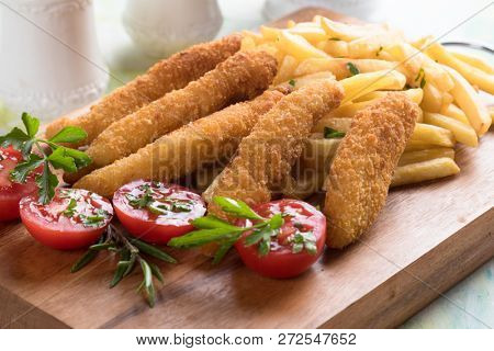 Deep fried chicken frites with potato chips or french fries
