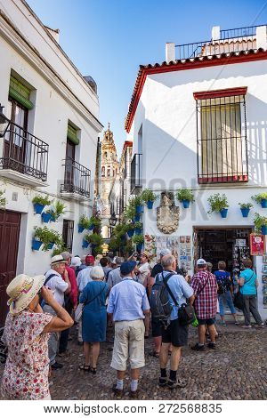 Cordoba, Spain. September 2016: Group Of Senior Tourist In Calleja De Las Flores Of Cordoba.