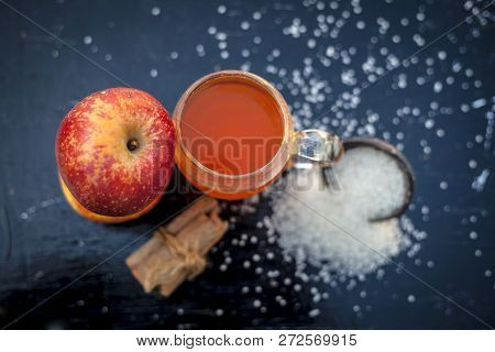 Apple Juice In A Transparent Glass With Two Raw Apples In  Side,close Up View.