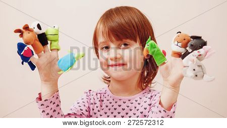 Finger Puppet Theatre. Cute Little Child Girl Playing With Toys Of Animals.