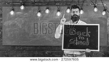 Back To School Concept. Teacher In Eyeglasses Holds Blackboard With Inscription Back To School. Man 
