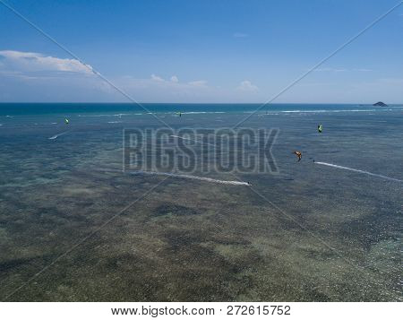 Kiteboarding, Kite Surf. Extreme Sports Kitesurfing In Tropical Blue Ocean, Clear Beach. Aerial View