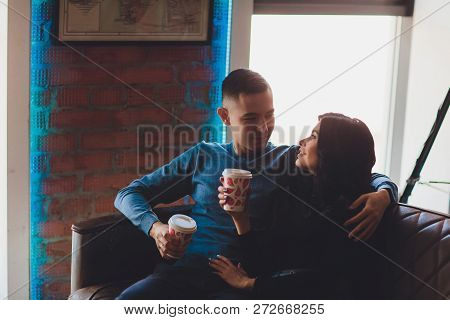 Beautiful Couple Sitting At Romantic Atmosphere Looking Each Other, Talking, Smiling And Drinking Wa