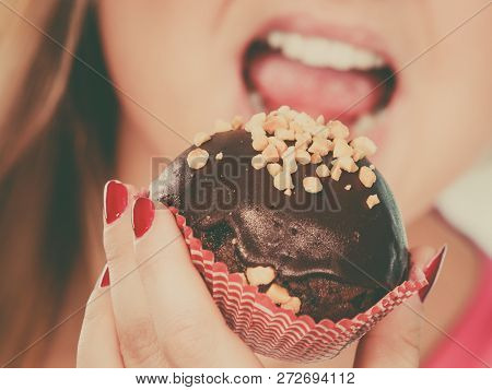 Diet, Sweets, Food Concept. Woman Holding Delicious Chocolate Cupcake With Peanut Frosting, Having W
