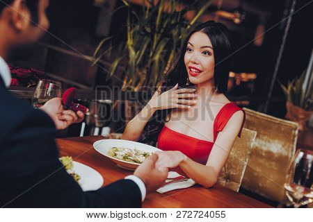 Hispanic Handsome Man Proposing To Girlfriend. Romantic Couple In Love Dating. Cutel Man And Girl In