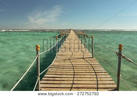 View At The Wooden Pier In The Red Sea. Summer Vacation On Red Sea. View At A Clear Sea With Turquoi