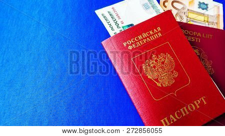 Passports On The Blue Background. Citizenship Of Estonia And Russia. Citizenship Of European Union (