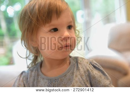 Face And Shoulders Portrait Of 2 Year Old Girl.