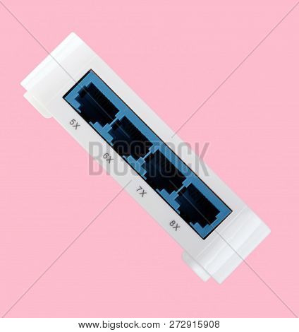 White 8 Port Plastic Ethernet Switch Isolated On Pink Background At Dry Day