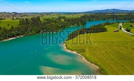 Aerial View Over Lake Forggensee At The City Of Fuessen In Bavaria Germany