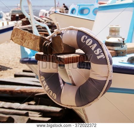 Lifebuoy Ring Hanging On The Bow Of A Coast Guard Boat In A Dock, Symi Island, Greece