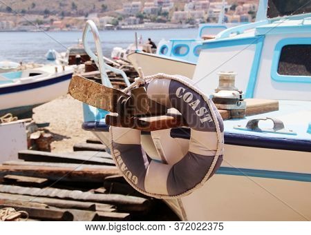 Lifebuoy Ring Hanging On The Bow Of A Coast Guard Boat In A Dock, Symi Island, Greece