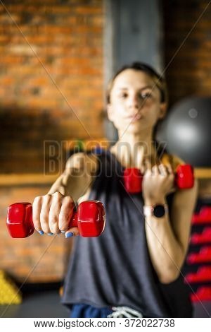 Young girl is doing fitness and different exercises in the gym.
Sport is health. Many sports equipme