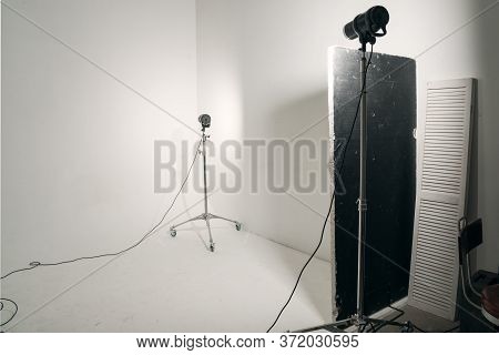Professional Studio Light Standing On White Cyclorama. Preshooting, Photoshooting Concept