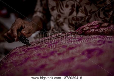 Indonesia June 18, 2020 : Batik, Close Up Hand And Canting, Making Batik Tulis Indonesia. Canting Is