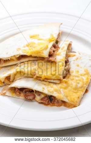 quesadilla filled with beans and chedar cheese