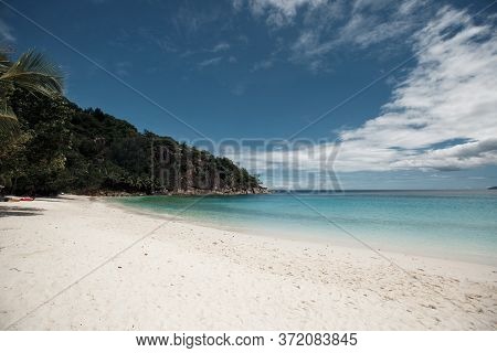 Beautiful Seychelles Island, Ocean Shore With White Sand And Blue Sky