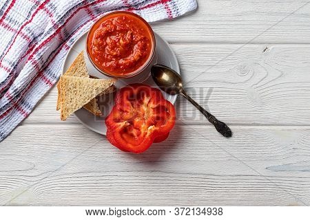 Ajvar Or Pindjur Red Vegetable Sauce, Paprika Pepper And Tomato Mousse On A Wooden Table. Serbian Tr