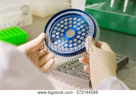 Dna Analysis On Medical Devices In The Hands Of A Physician With Gloves In The Process Of Installati