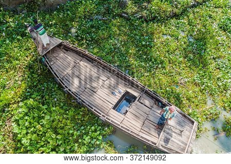 Katcha River, Bangladesh - November 19, 2016: Two Men On A Small Boat Stuck In A Vegetation On Katch