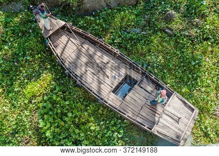 Katcha River, Bangladesh - November 19, 2016: Two Men On A Small Boat Stuck In A Vegetation On Katch