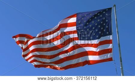 Usa Flag On Flagpole. American Flag - Symbol Of Freedom And Law In The Usa. American Flag Flies In T